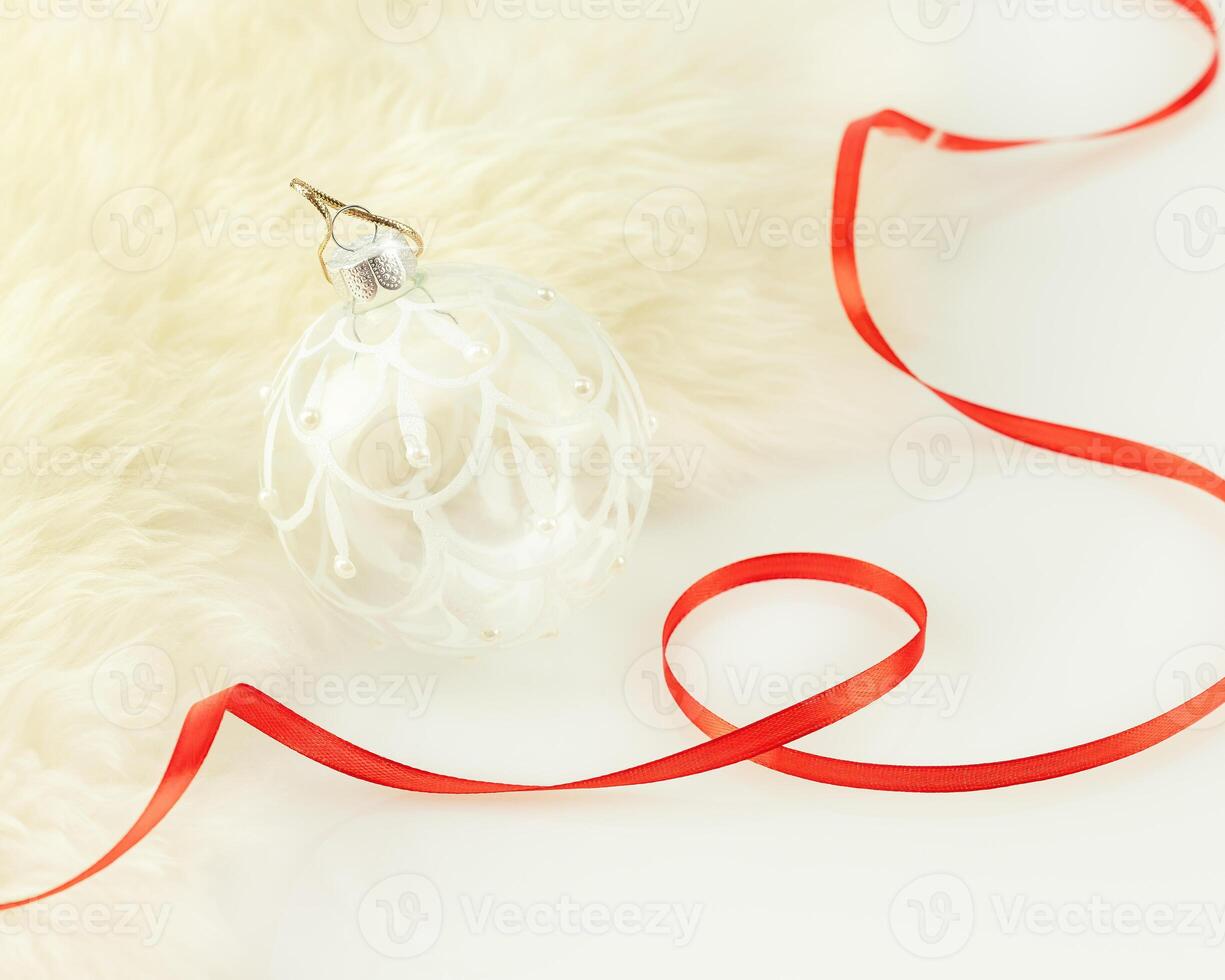 Christmas and New Year card with new year ball and red ribbon photo