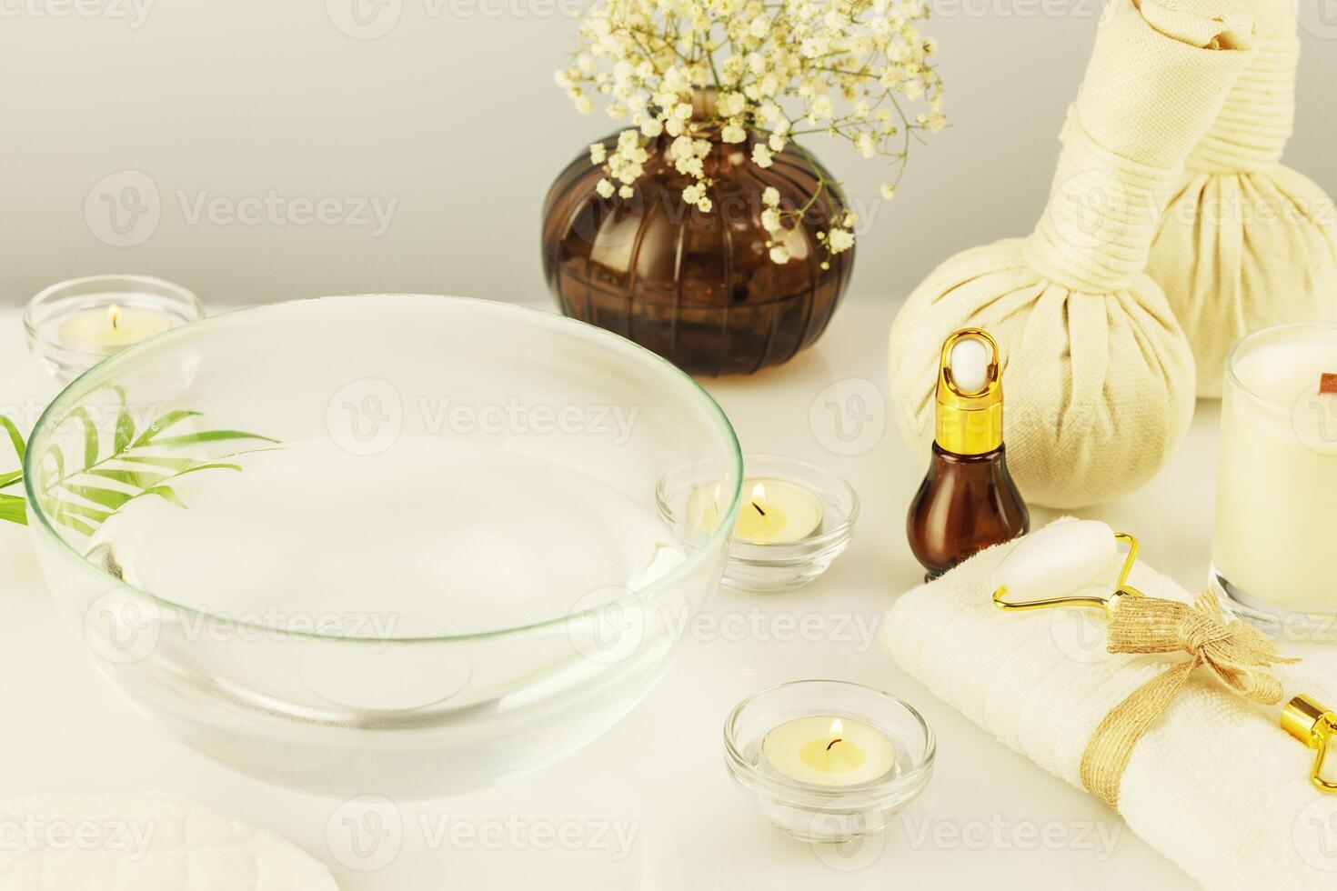 Cosmetology products, spa accessories and candles on a white table photo