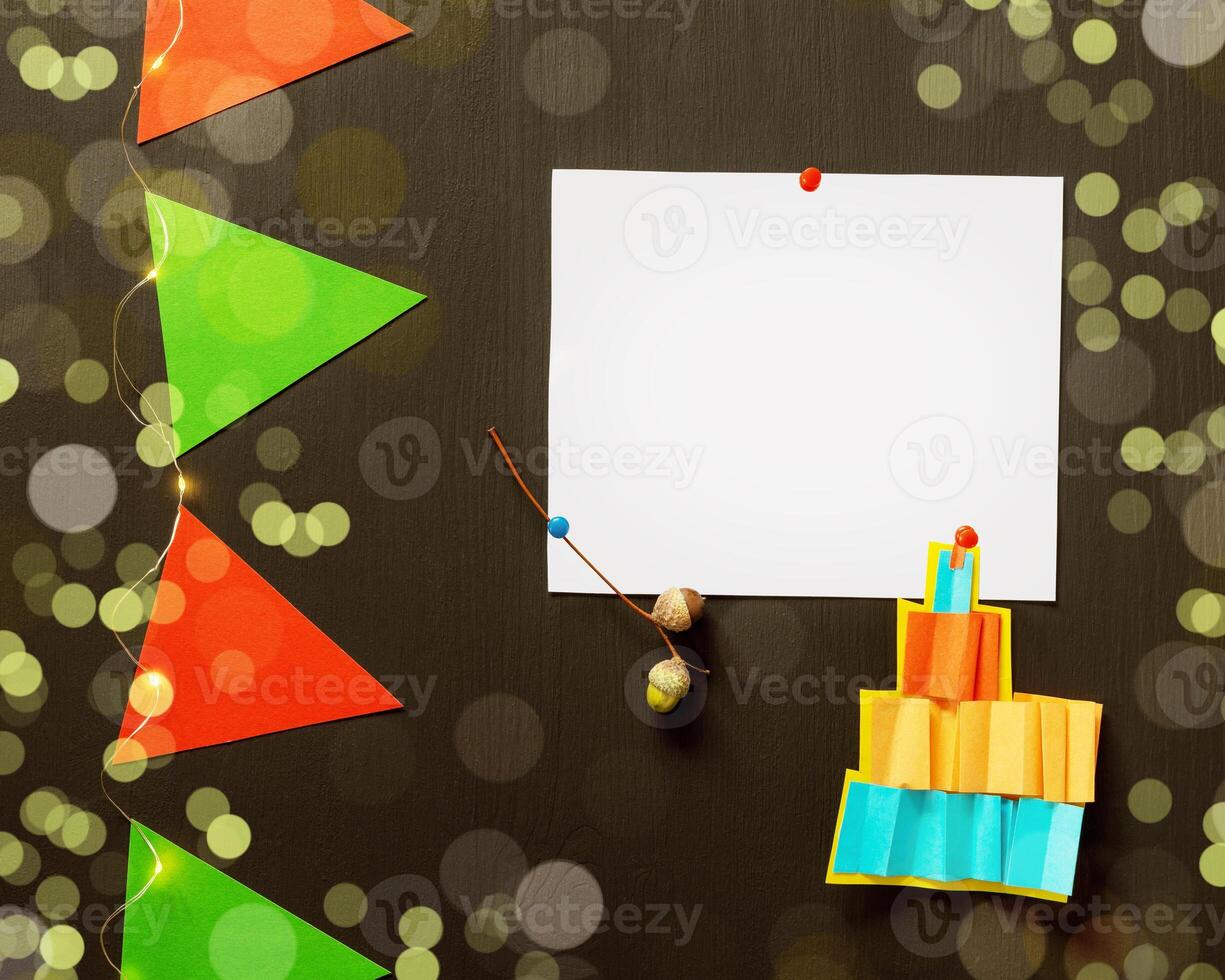 Holiday background with white sheet, garland and bokeh effect photo
