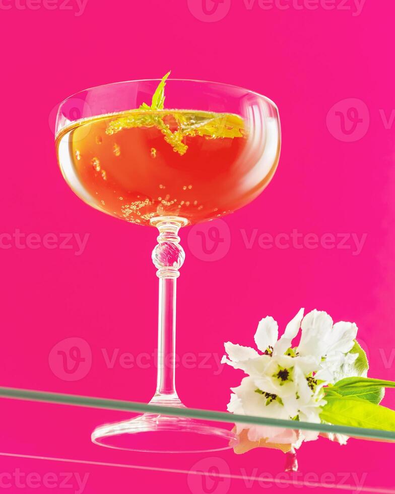 A Glass of apple cider with mint and apple blossoms photo