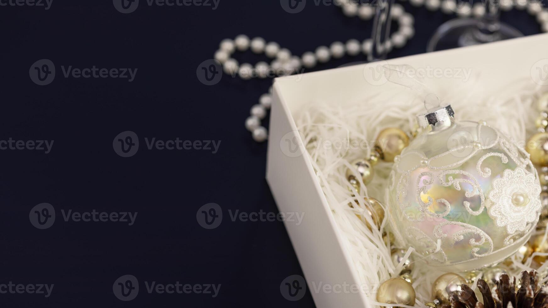 Christmas and New Year balls and decoration in a white paper box photo