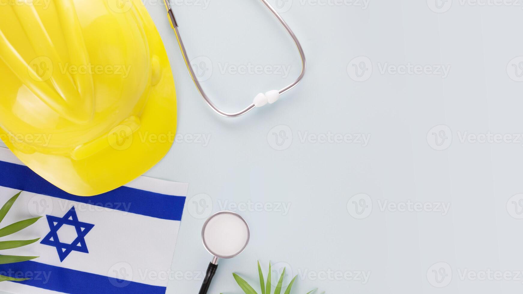 Israeli flag, stethoscope and hardhat on a blue background photo
