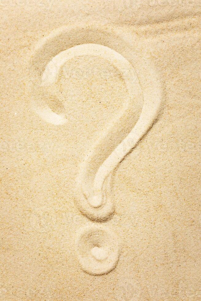 A question mark painted on the sand photo