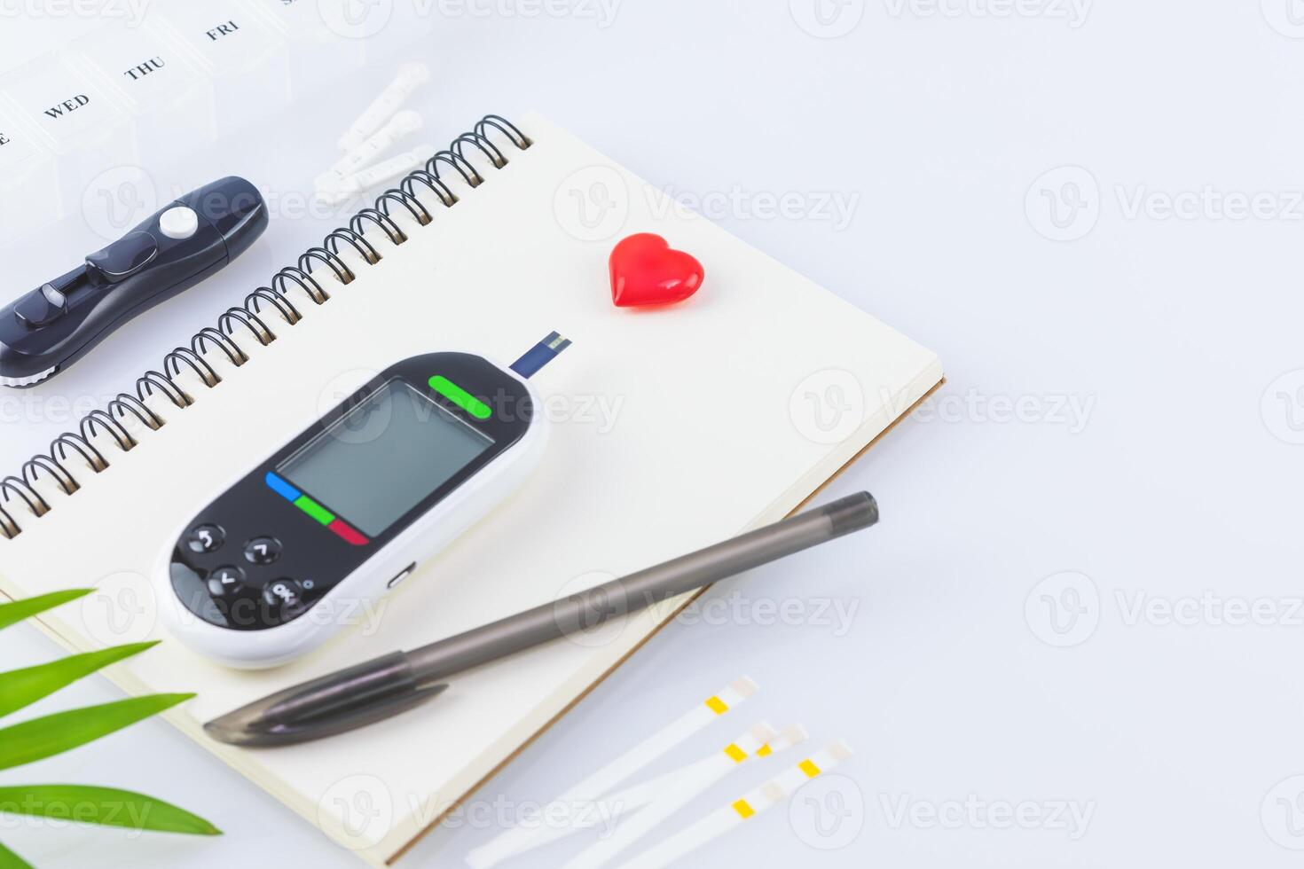 Diabetes control concept with glucose meter and note pade photo