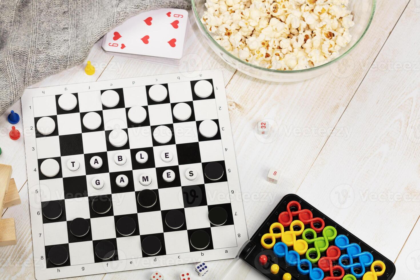 Checkers, puzzle, cards, dominoes, jenga on a wooden floor photo
