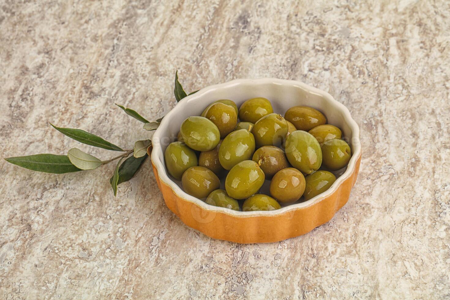 Tasty marinated olives in the bowl photo