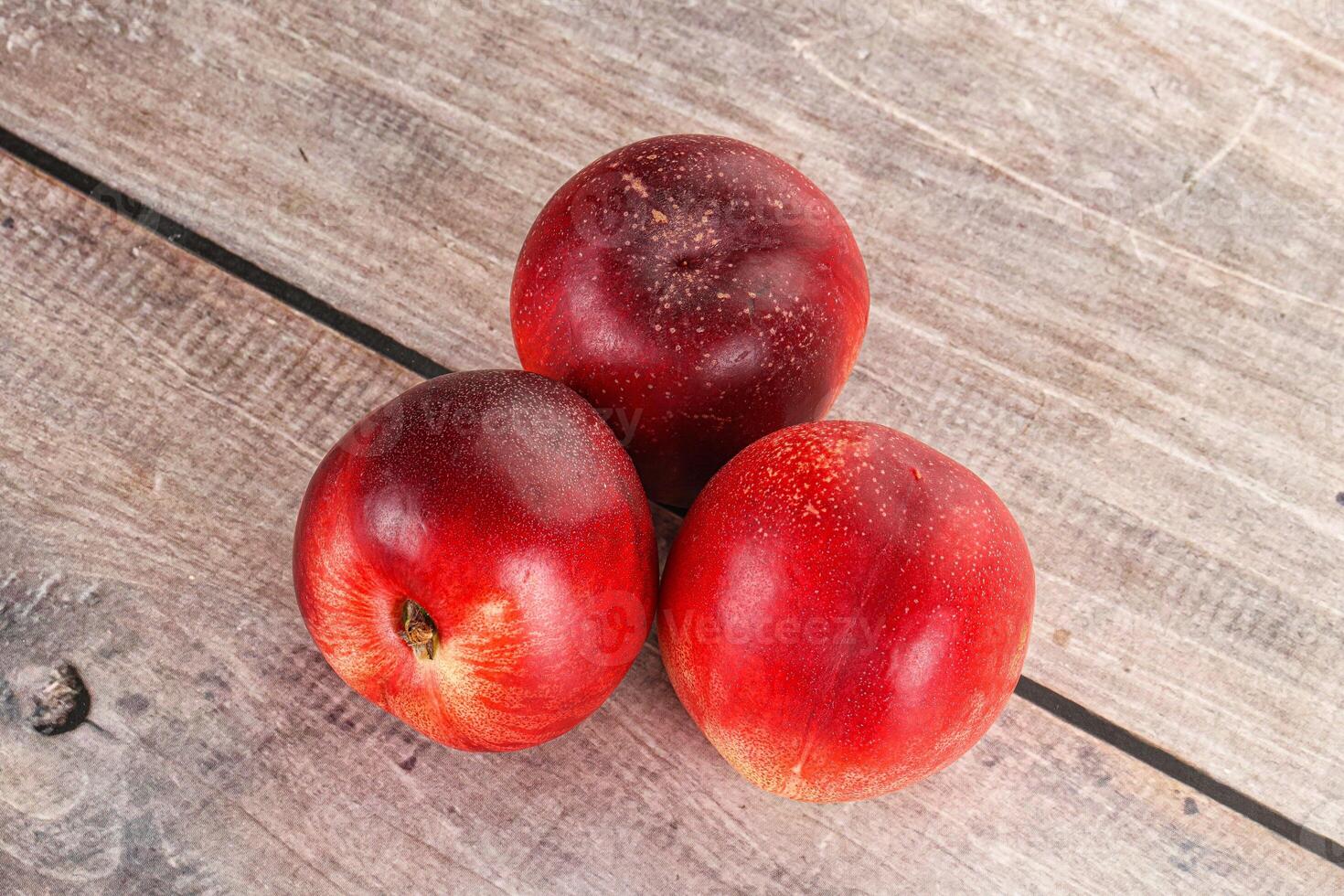 Ripe sweet juicy nectarines heap photo