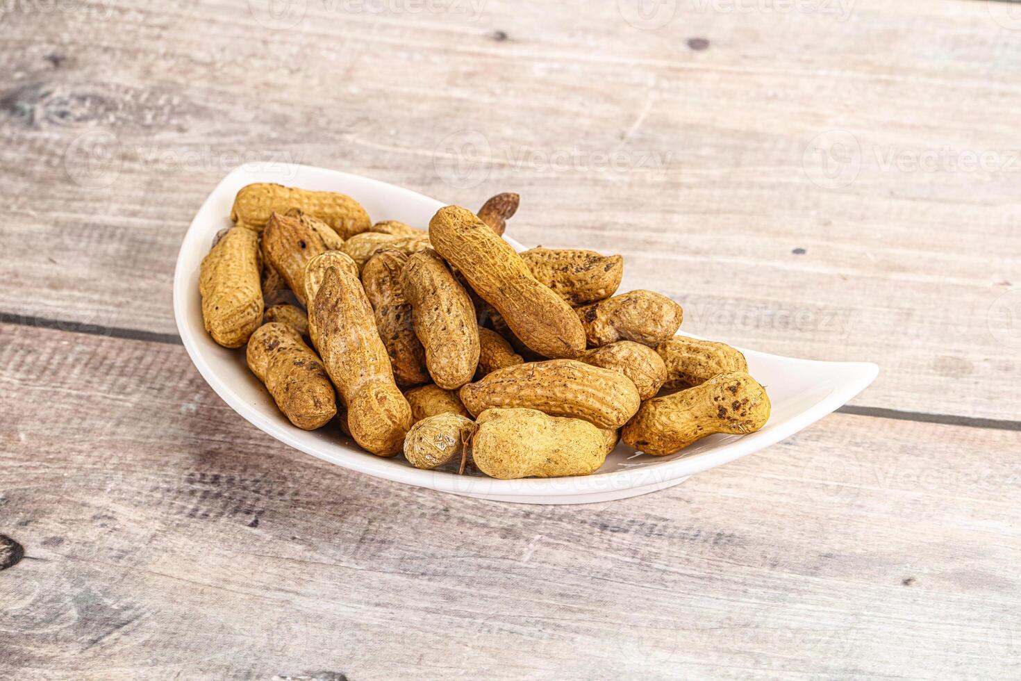Raw ripe unpeeled peanut heap photo