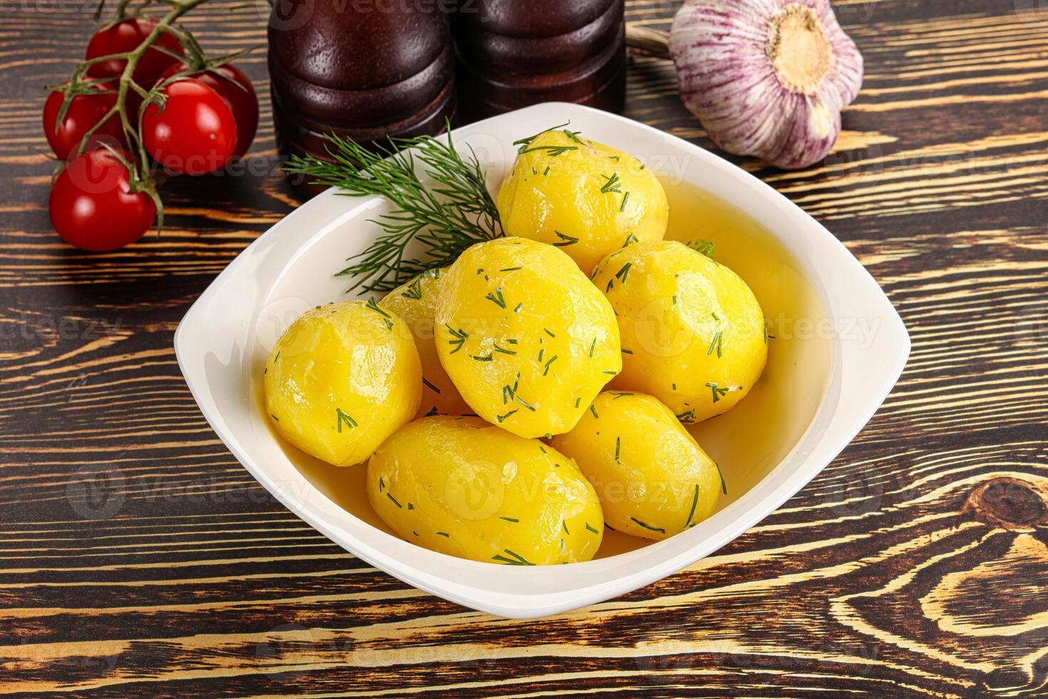 Boiled potato with oil and dill photo