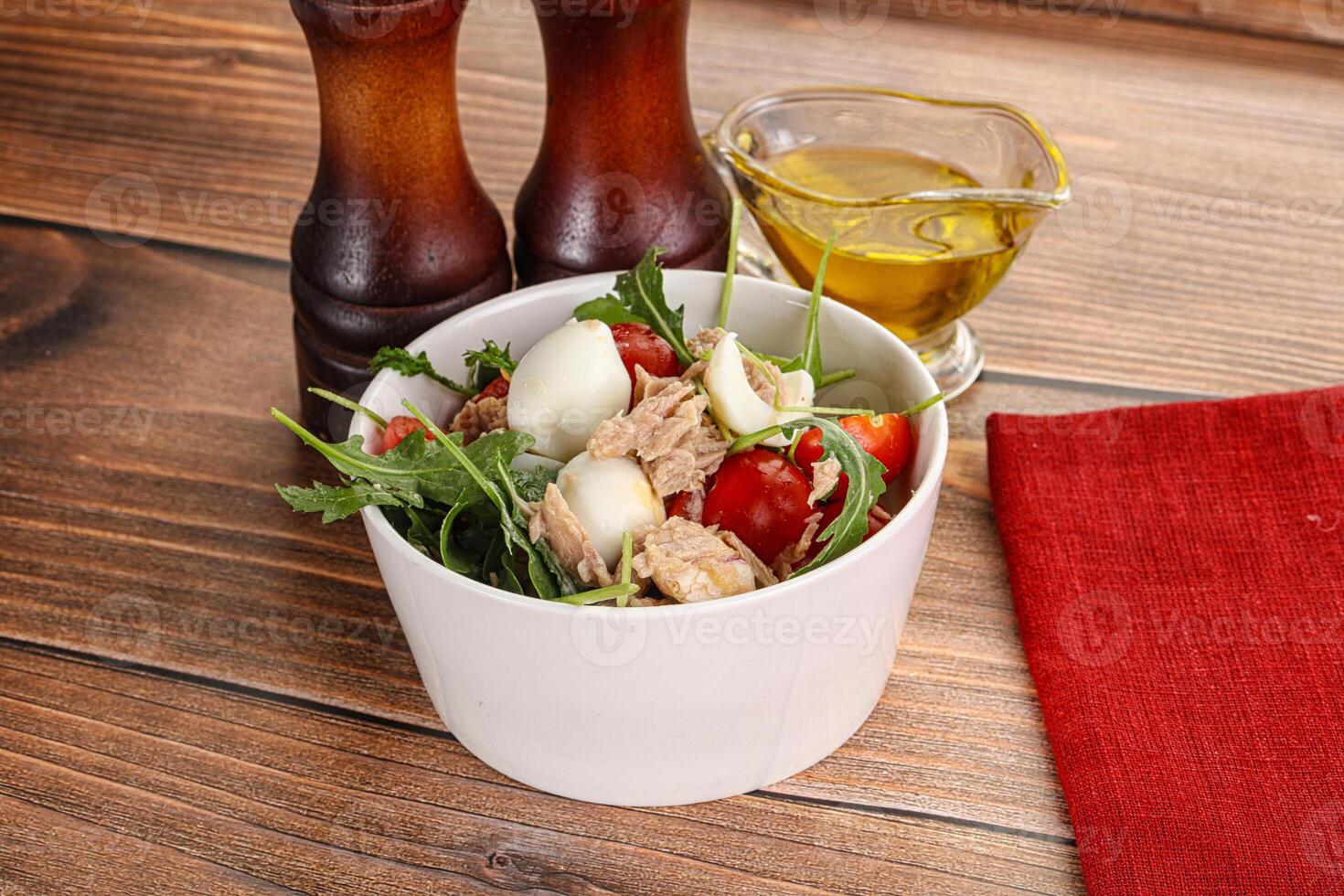 Salad with tuna, tomato, quail egg and arugula photo