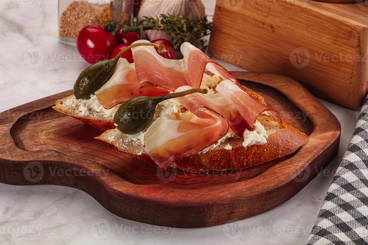 Bruschetta with jamon and caper berries photo