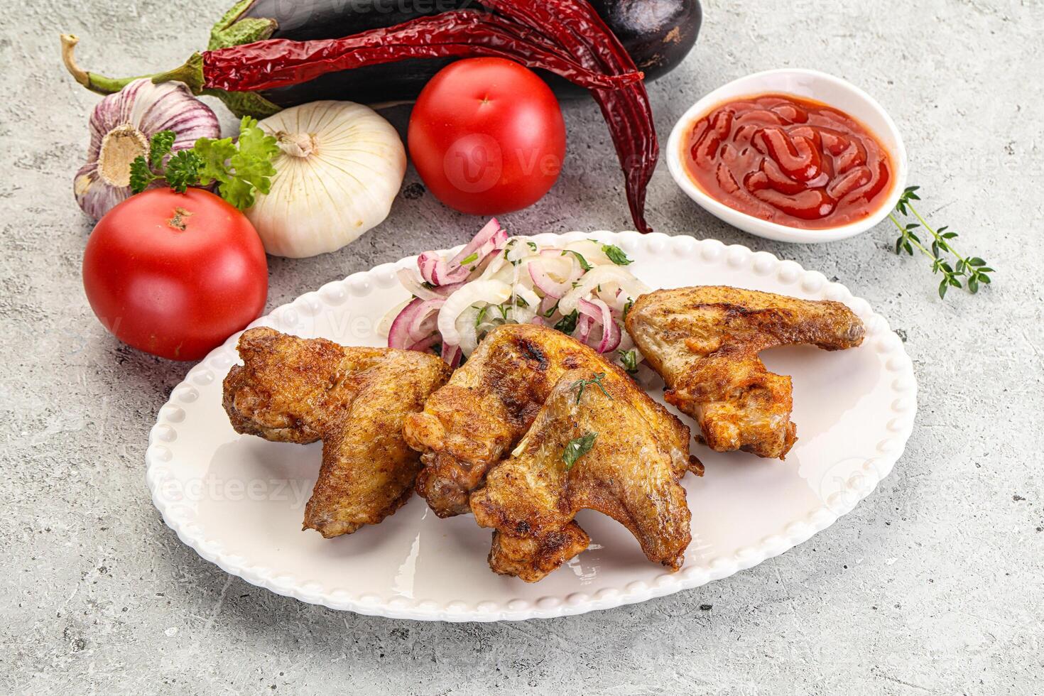 Grilled chicken wings with sauce photo