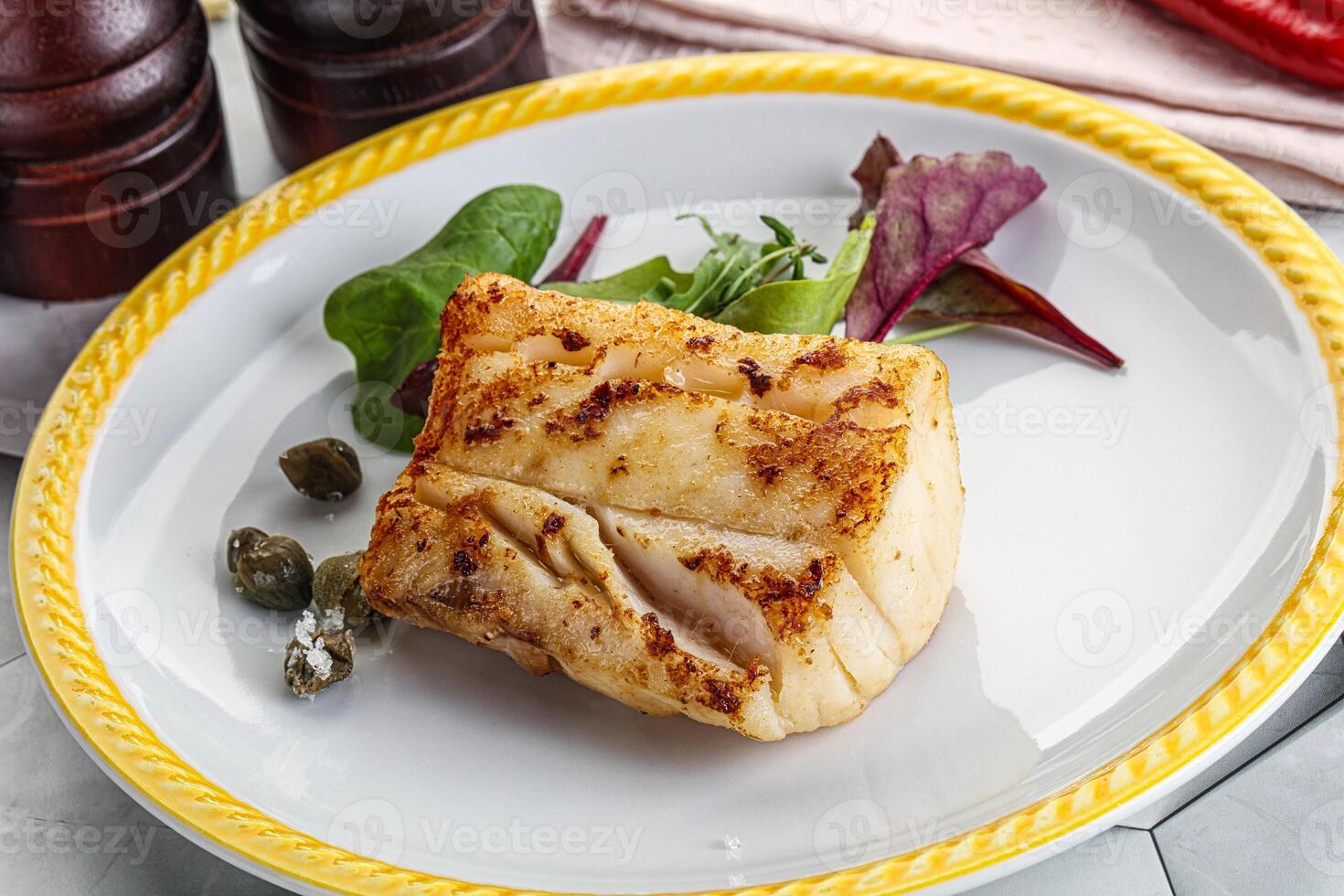 Roasted cod fish steak with salad photo