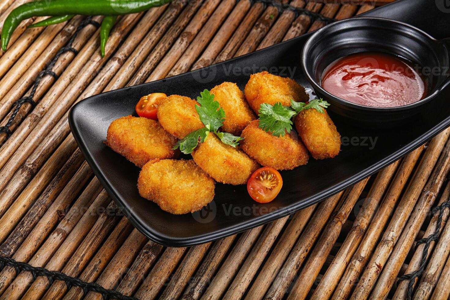Crispy golden choclen nuggets with sauce photo