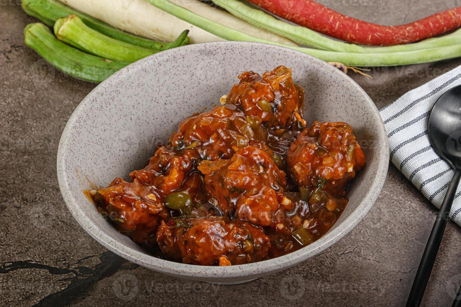 Manchurian chicken with sauce and spices photo