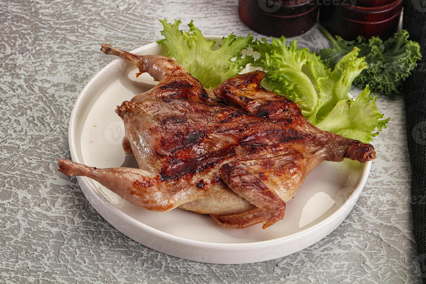 Grilled quail in the plate photo