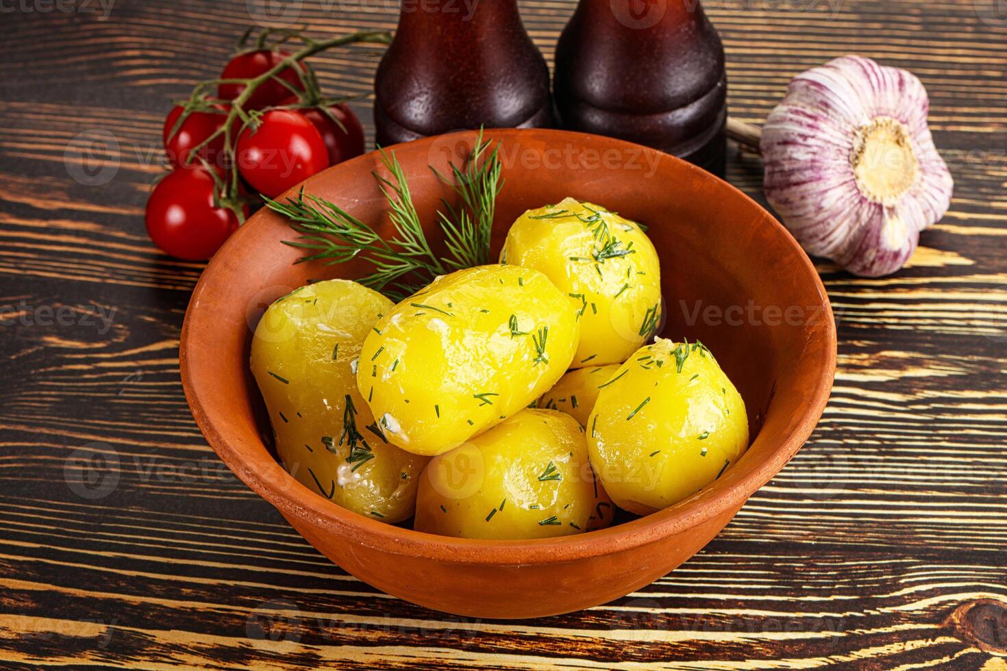 Boiled potato with oil and dill photo