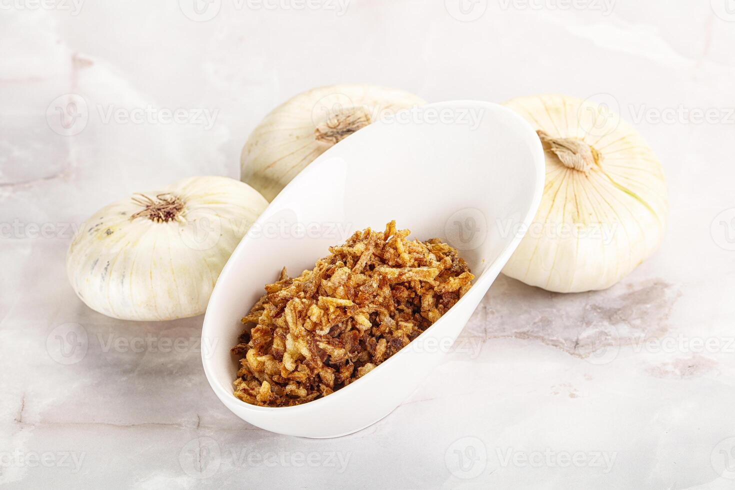 Dried roasted onion flakes for culinary photo