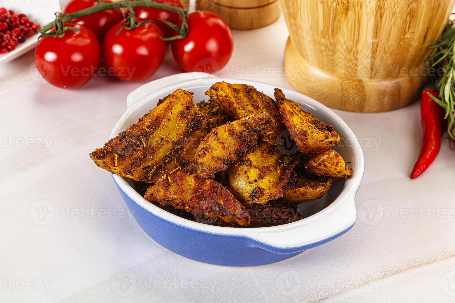 Golden baked potato Idaho with spices photo