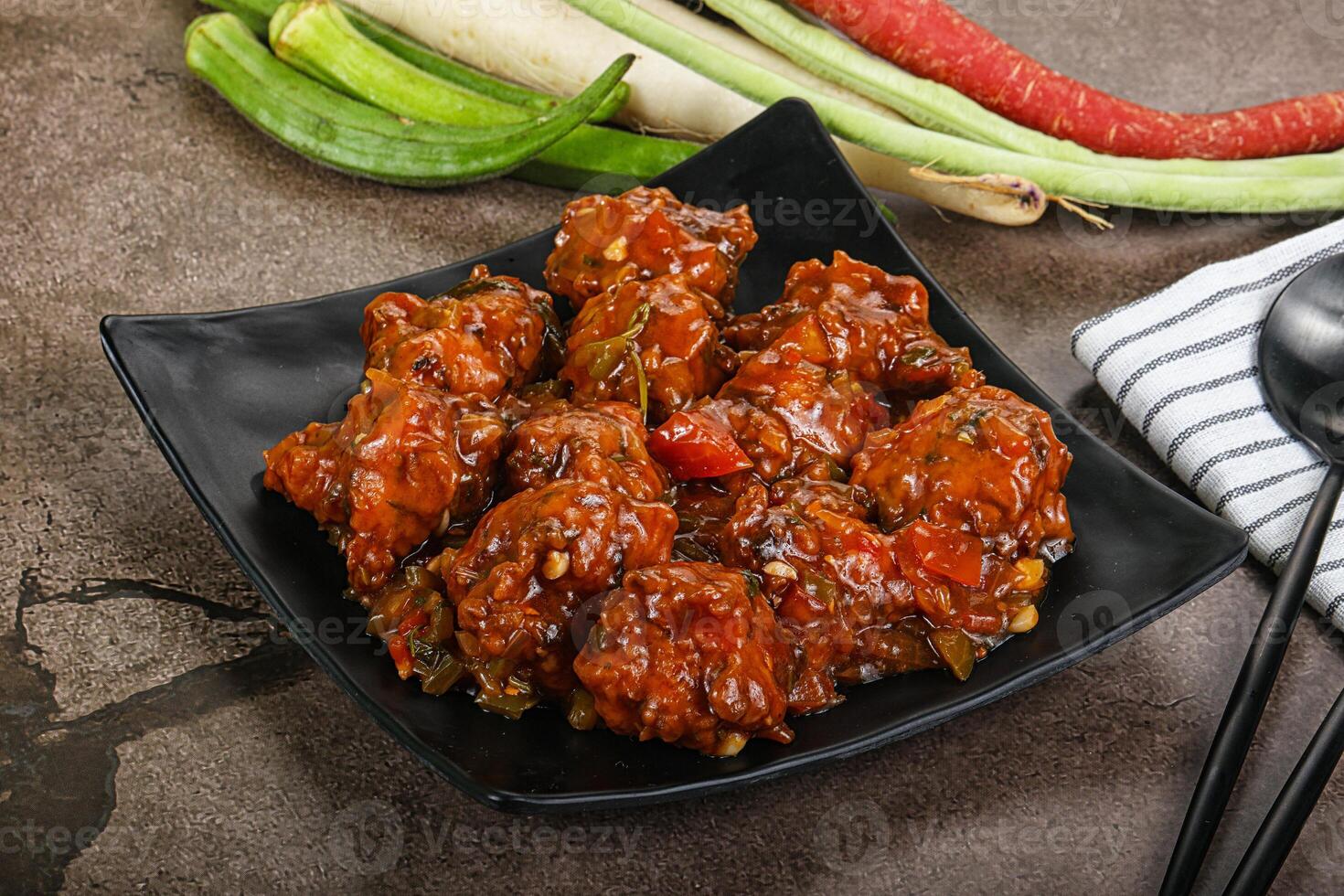 Manchurian chicken with sauce and spices photo