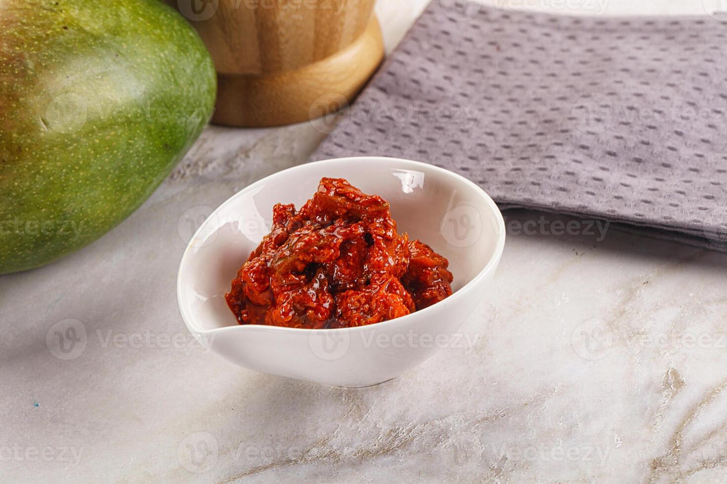 Spicy pickled raw green mango photo