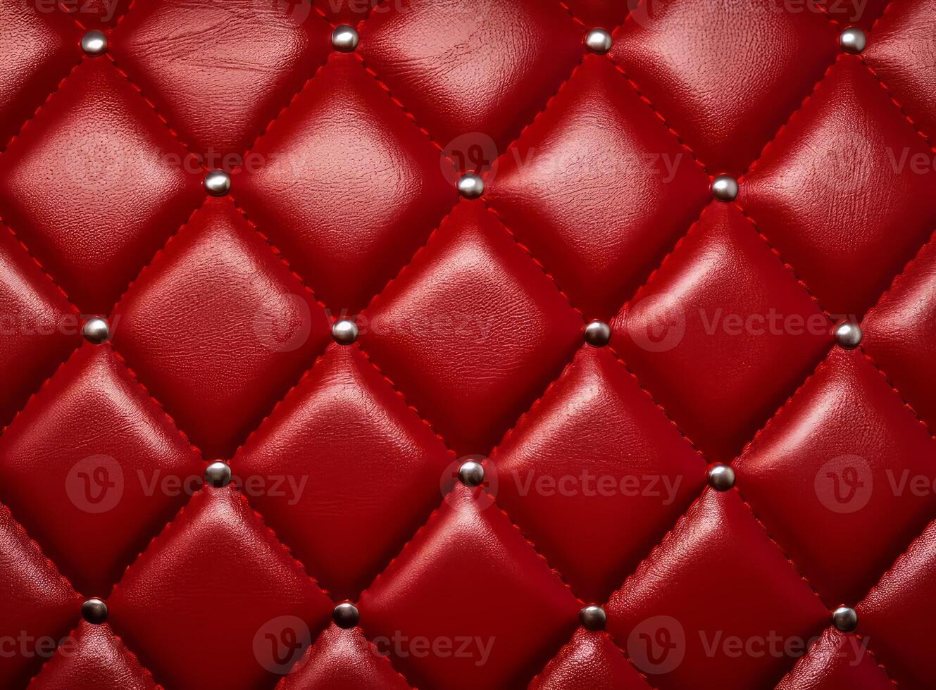 A close-up view of a luxurious red leather upholstery with decorative studs. photo