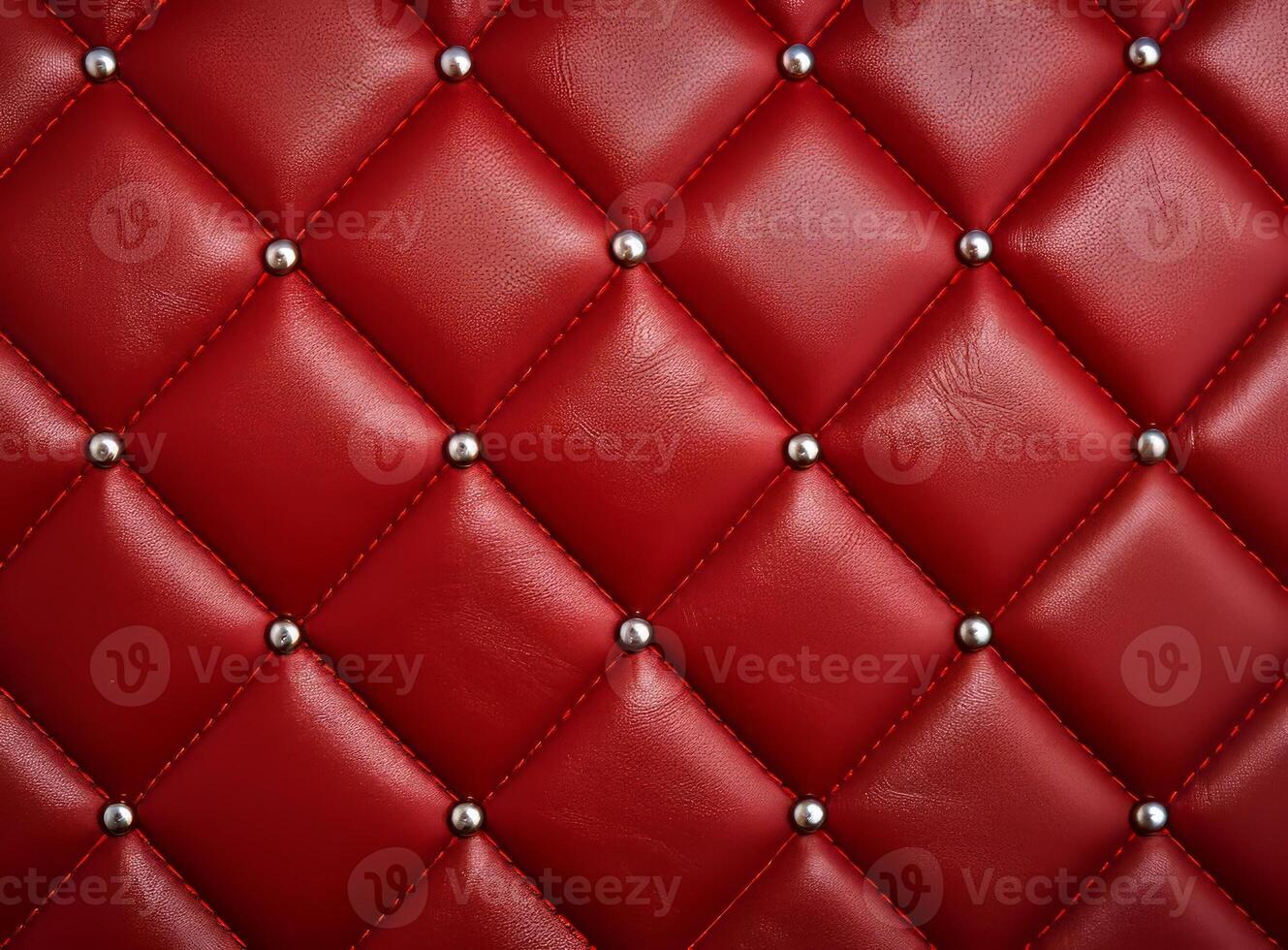 A close-up view of a luxurious red leather upholstery with decorative studs. photo