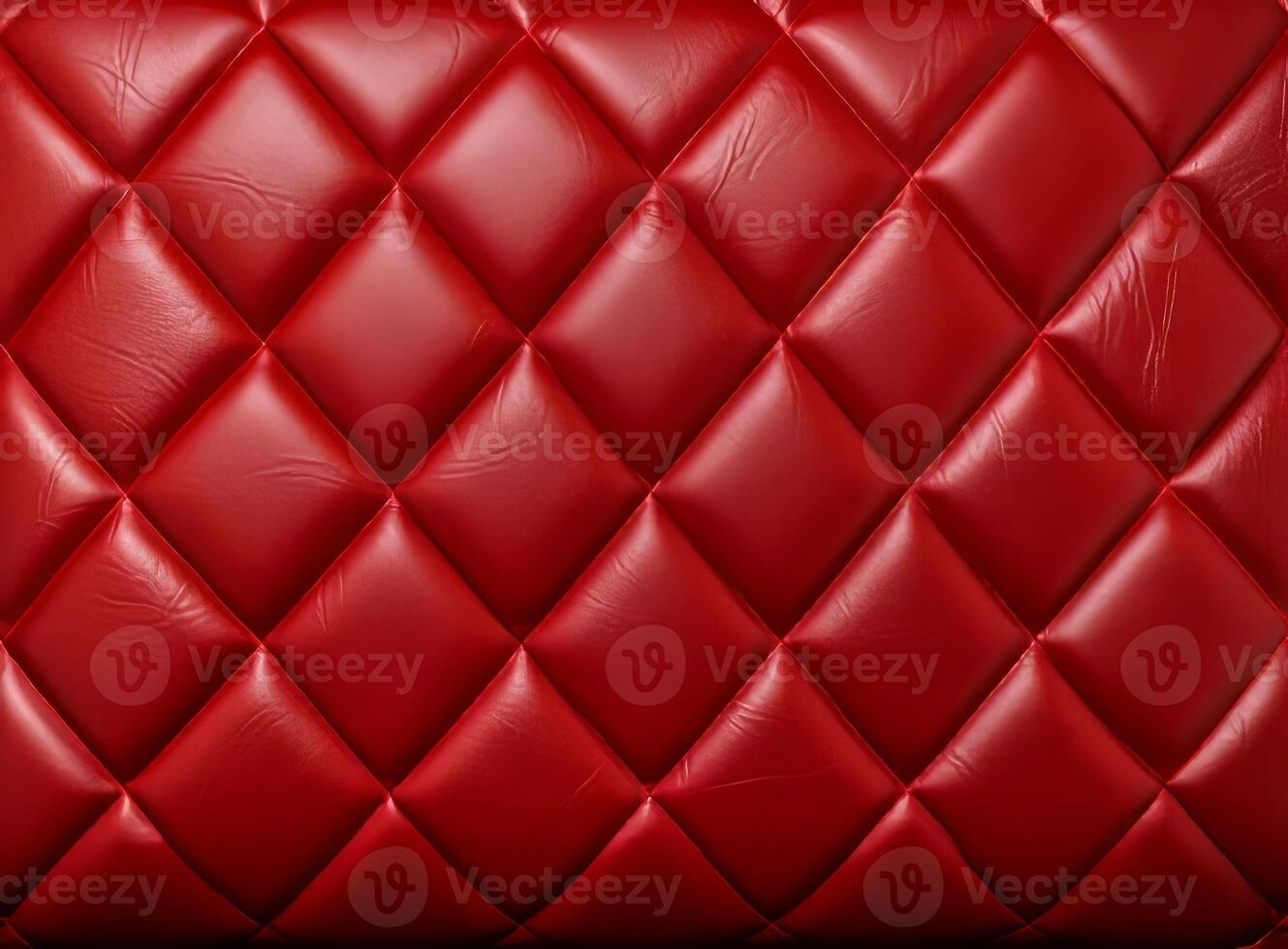 Luxurious red leather material with a classic diamond stitching pattern. photo