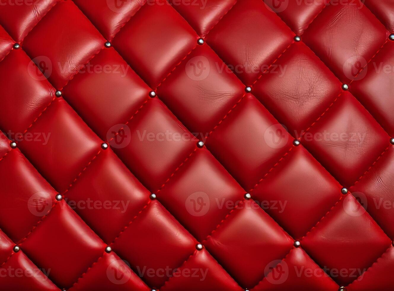 A close-up view of a luxurious red leather upholstery with decorative studs. photo