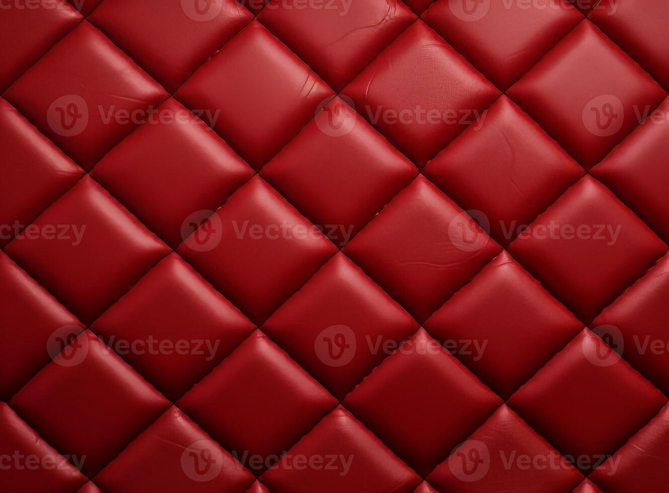 Luxurious red leather material with a classic diamond stitching pattern. photo