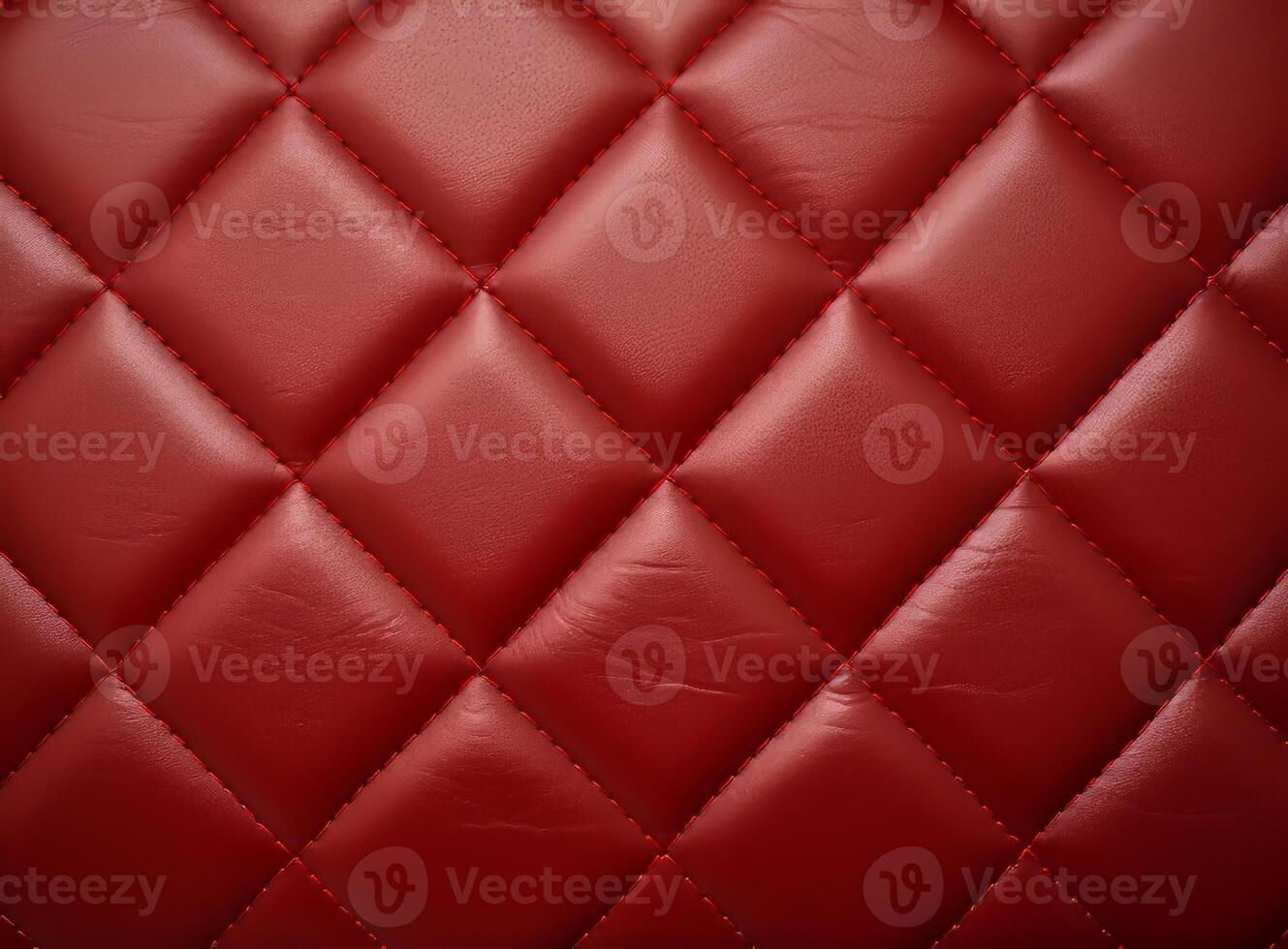 Luxurious red leather material with a classic diamond stitching pattern. photo