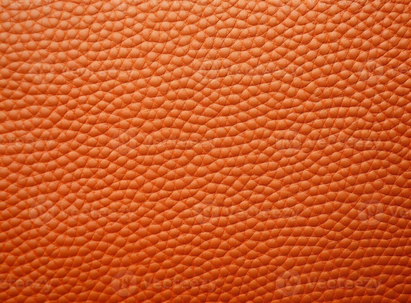 Close-up leather with a smooth, slightly uneven texture. photo