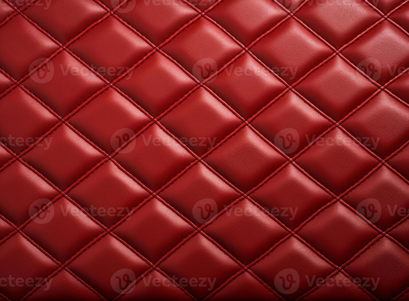 Luxurious red leather material with a classic diamond stitching pattern. photo