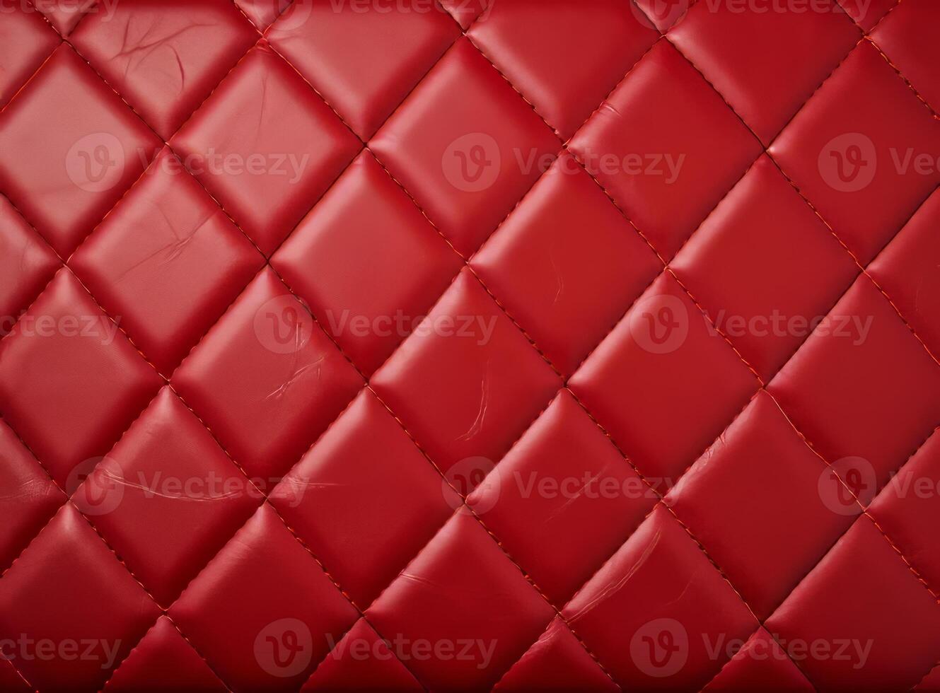 Luxurious red leather material with a classic diamond stitching pattern. photo