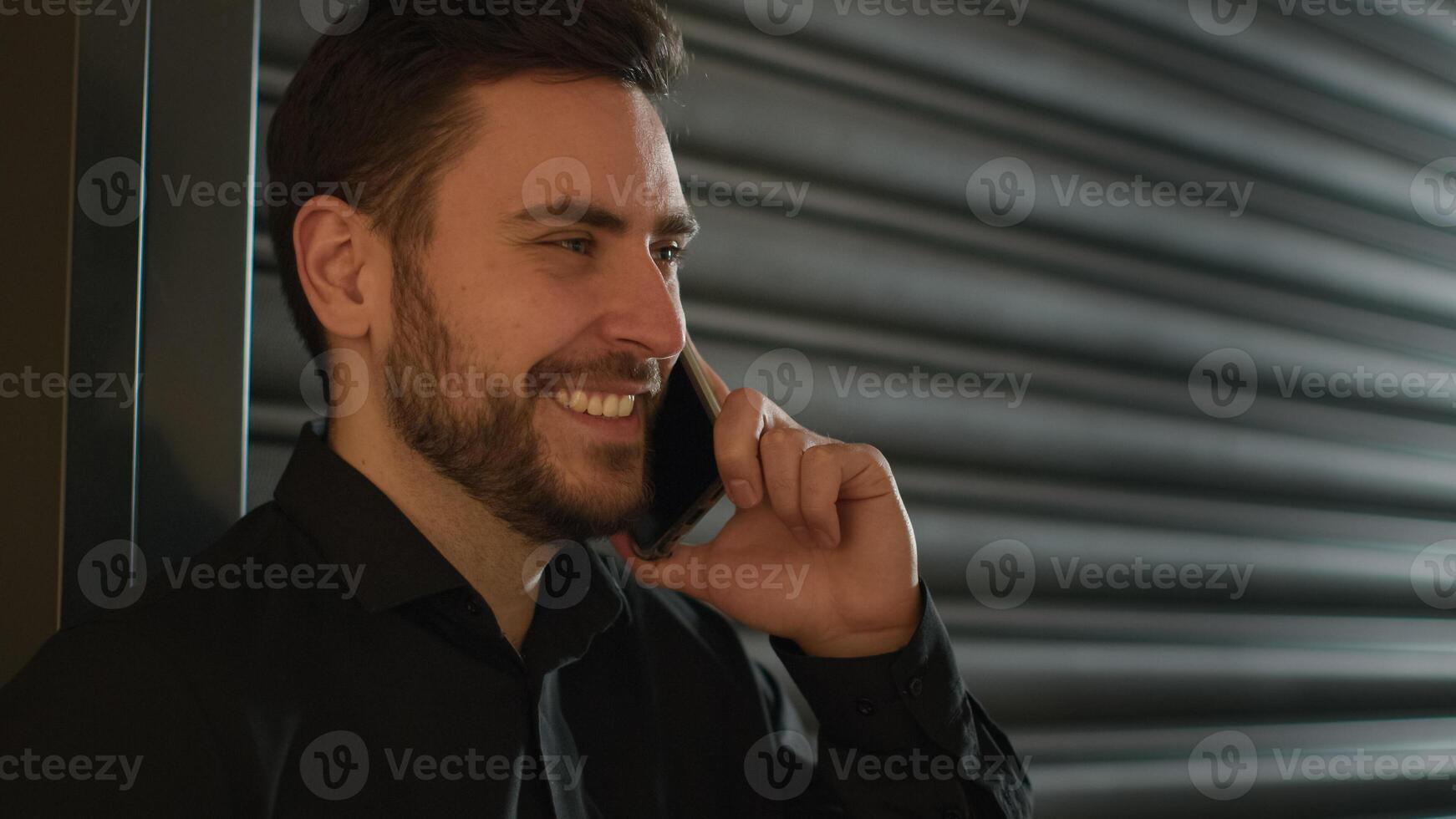 Caucasian office worker businessman commercial CEO cheerful entrepreneur talking mobile phone speak smartphone business call at workplace calling cellphone negotiate smiling man talk discuss indoors photo