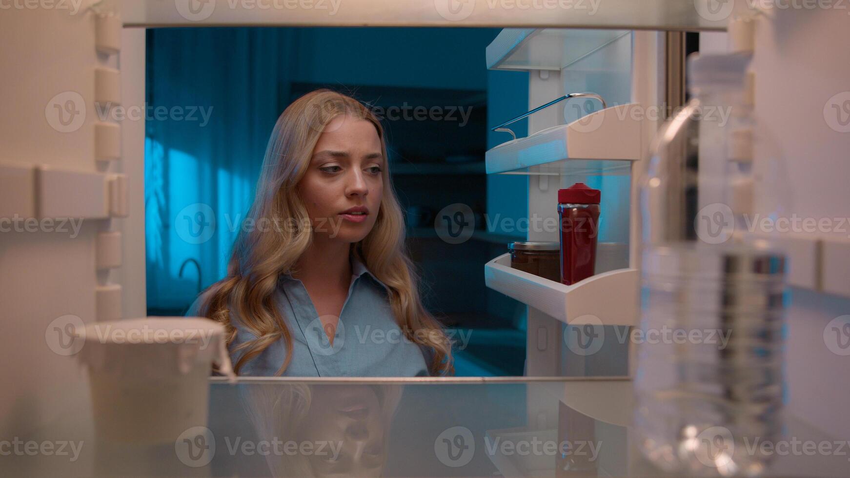 Point of view POV inside refrigerator Caucasian girl hungry woman open fridge at home kitchen look at empty shelves order food products delivery with mobile phone app online service web store shopping photo