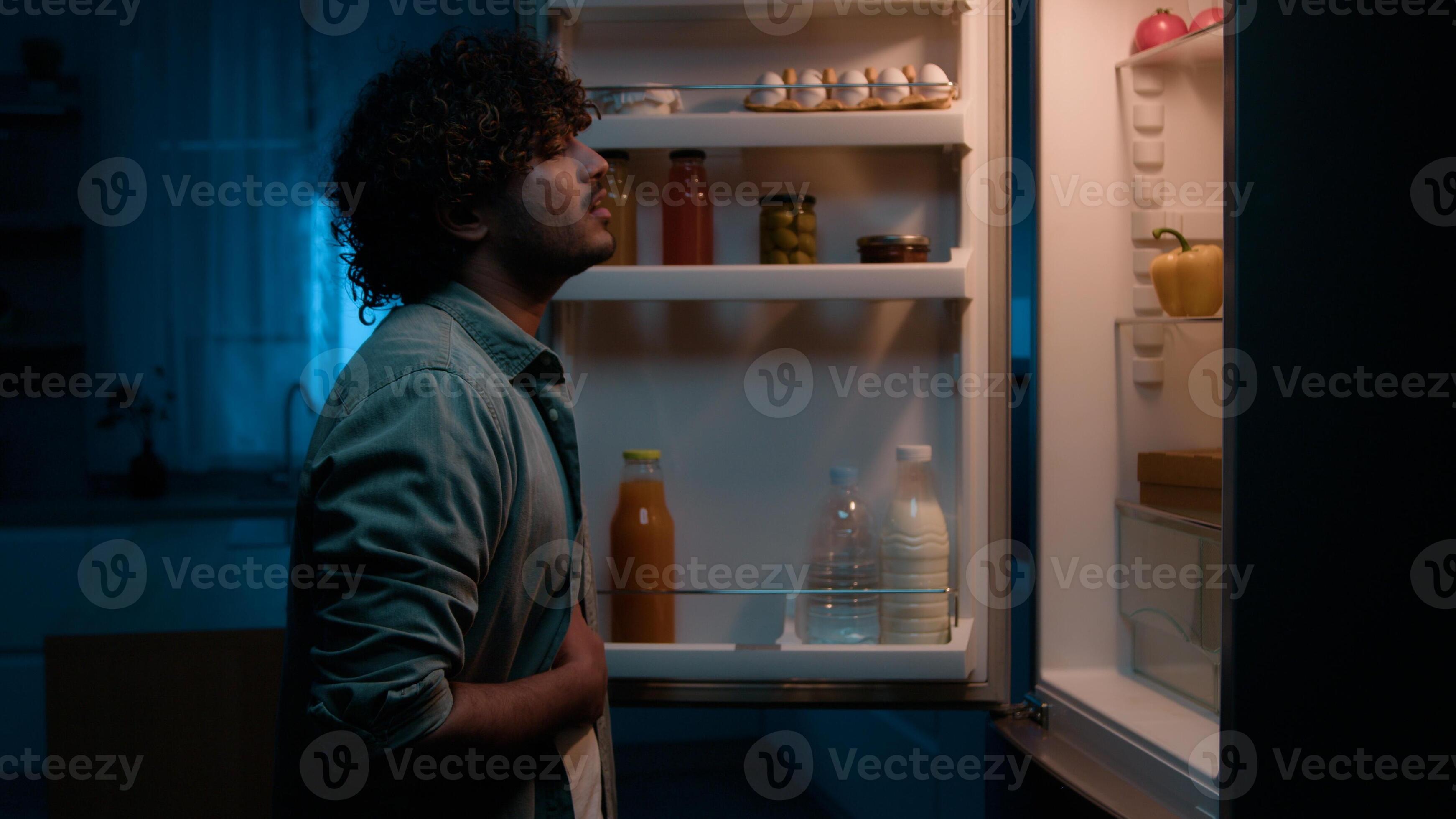 Home kitchen at night dark room hungry Hispanic man Indian male guy ...