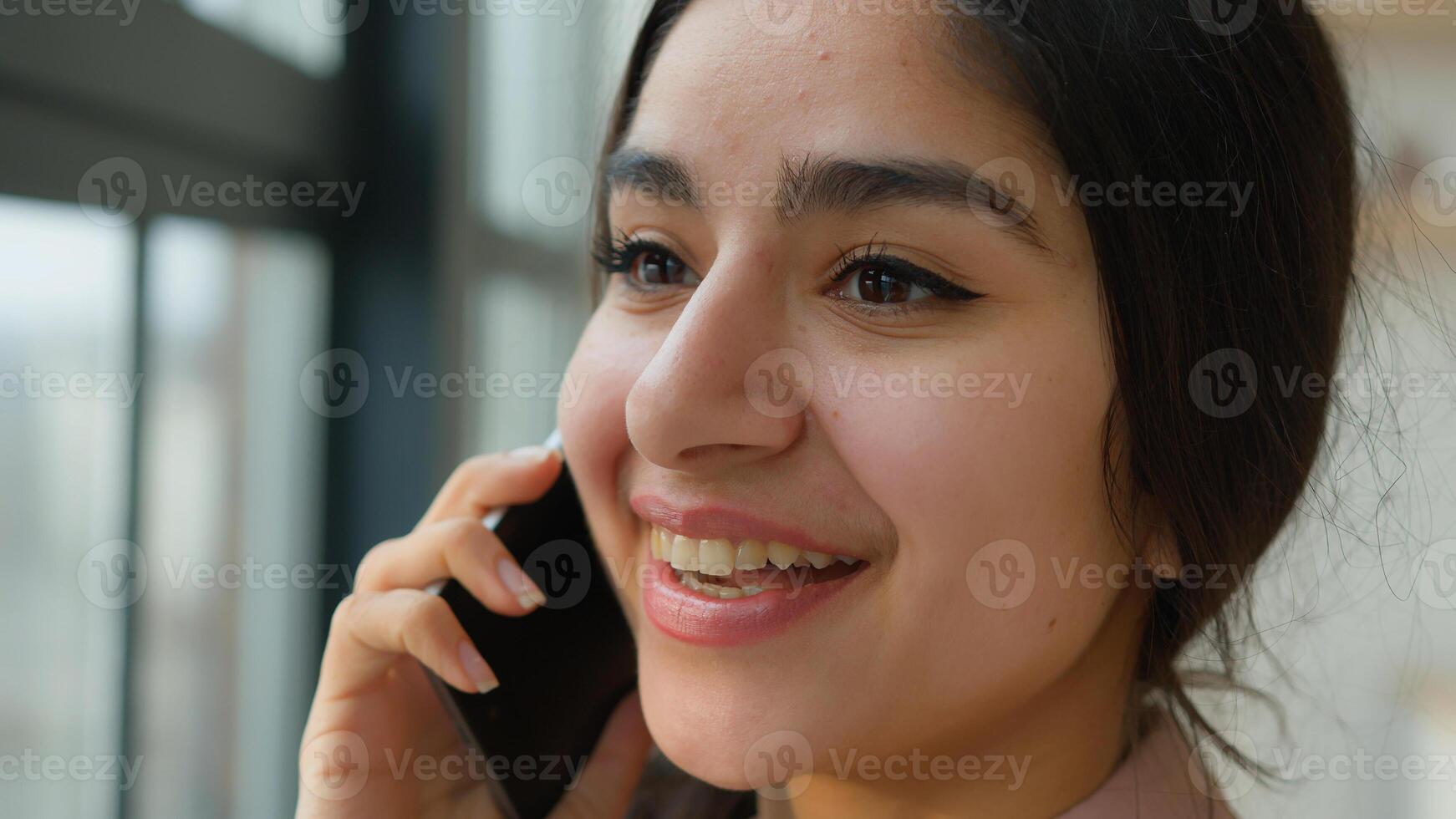 Close up head shot Arabian girl talking mobile phone near window smiling female businesswoman lady speak business call Indian woman at home office calling laughing talk smartphone distant conversation photo