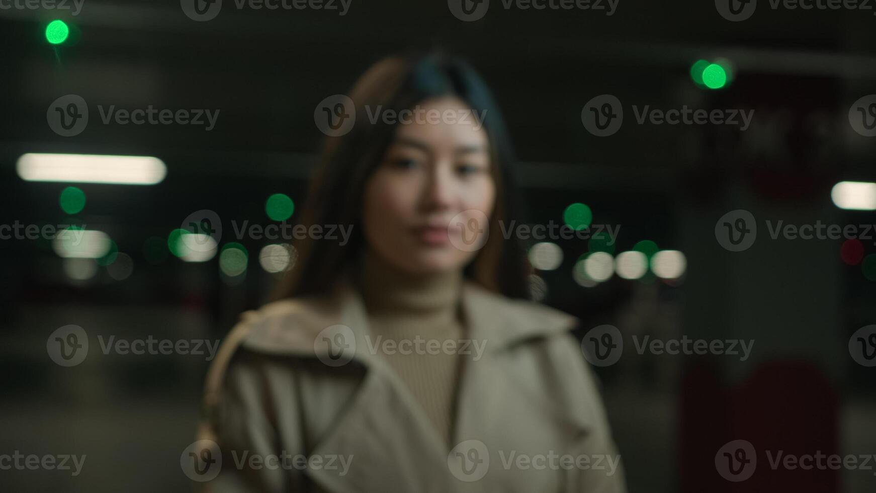 Blurred portrait Asian chinese japanese woman korean girl looking at camera female businesswoman car driver in underground parking blurry moving shot ethnic lady auto agent trader ceo posing indoors photo