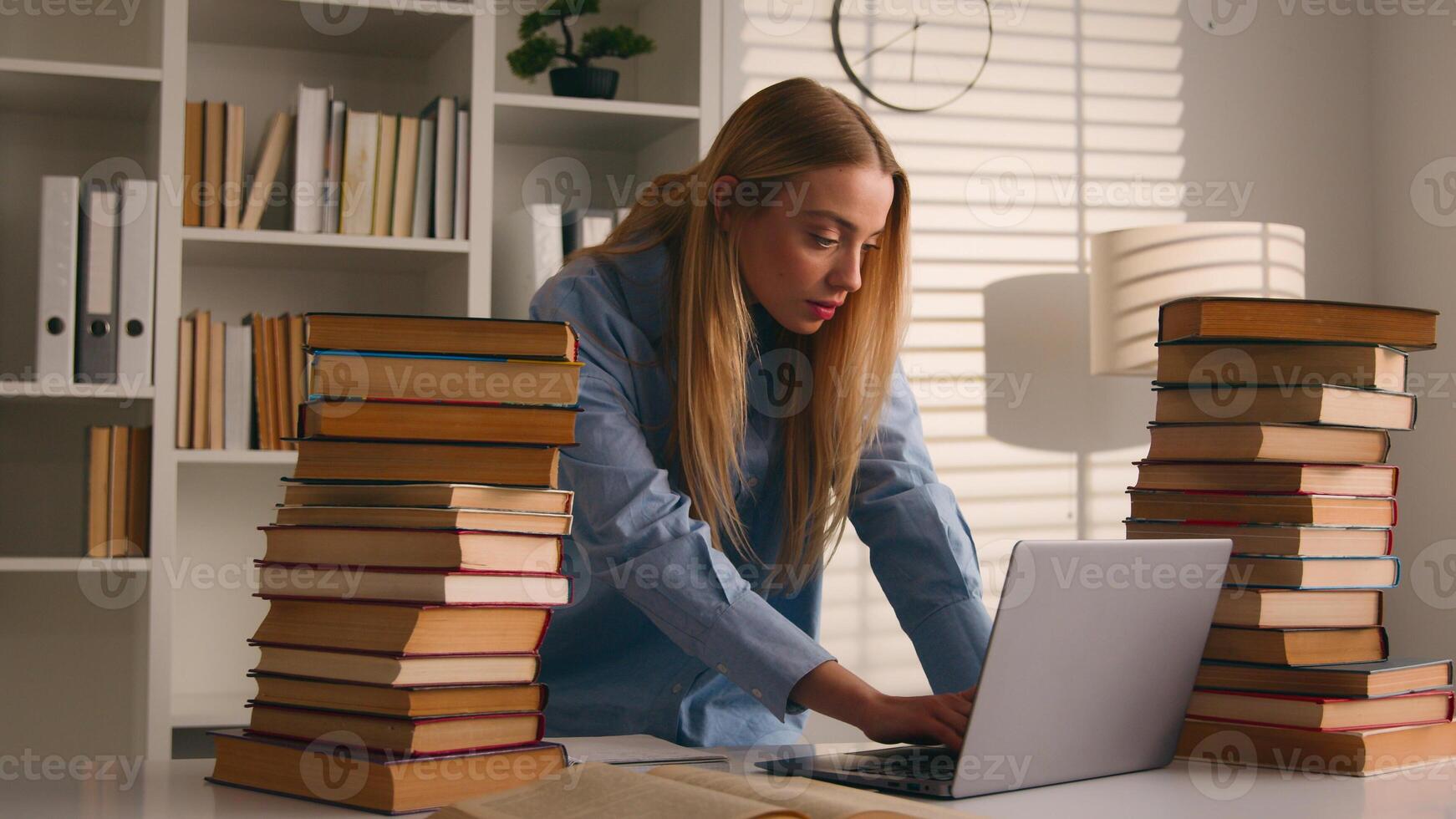 Caucasian student girl high school female university leaner woman studying with laptop and books write homework writing task learning class lesson online prepare for test exam study at home in library photo