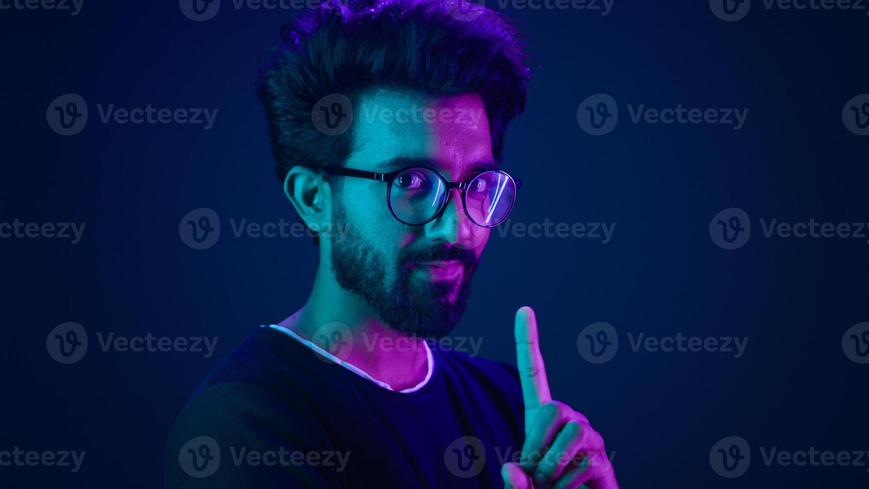 Ultraviolet neon background Arabian man hi-tech internet technology worker male coder computer hacker waving finger no not never reject deny negative attitude forbid system modern high-tech software photo