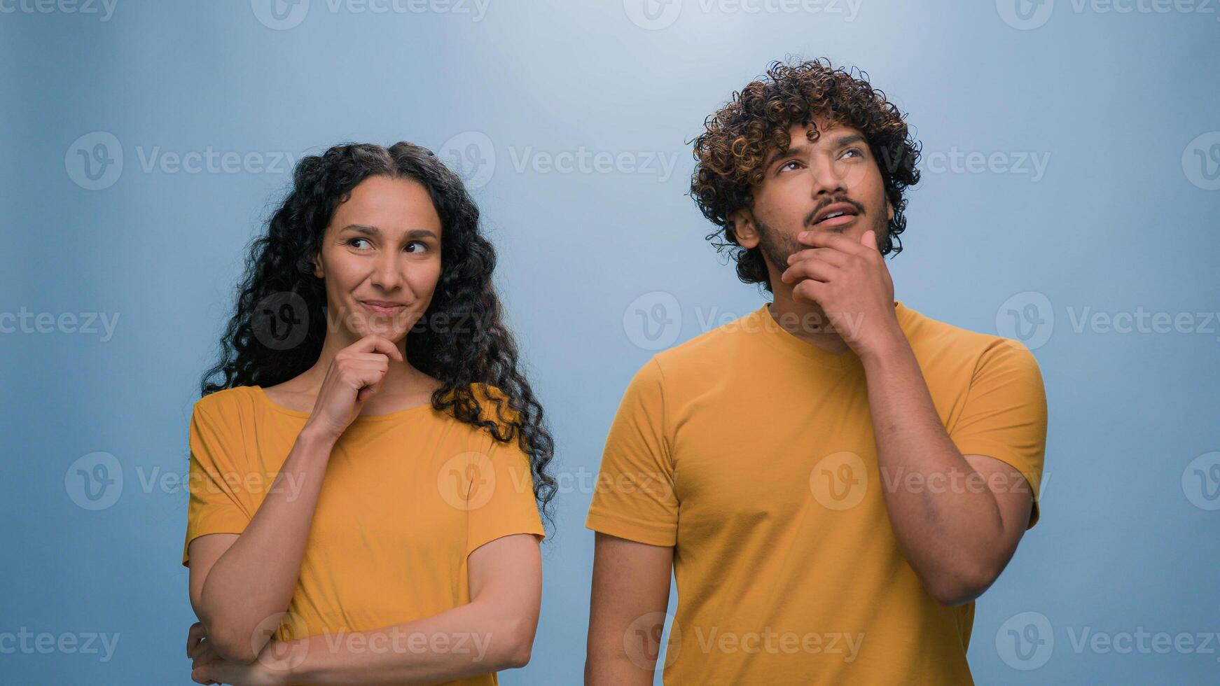 Multiracial diverse couple two friends family man woman together think pondering problem decision solution thoughtful pensive thinking come up with idea isolated on blue background studio portrait photo