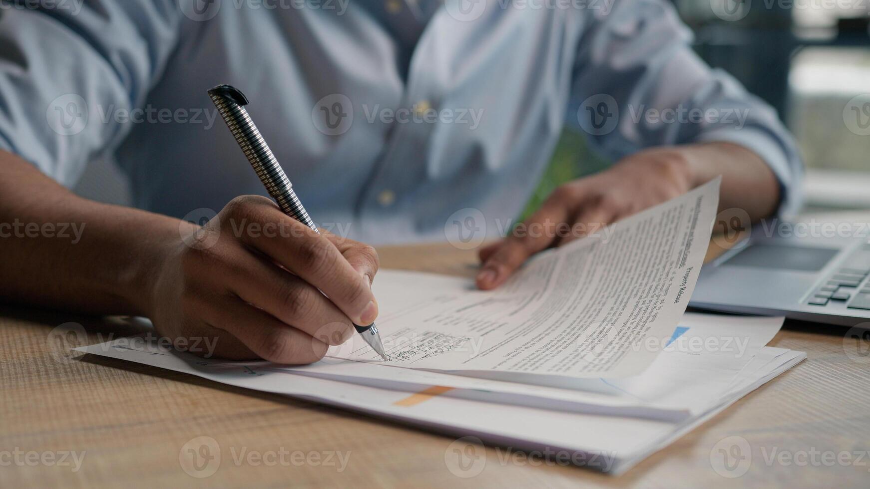 Close up male hands writing exam in class business paperwork with glass of water on office desk unrecognizable man businessman student studying write paper notes document text form insurance summary photo