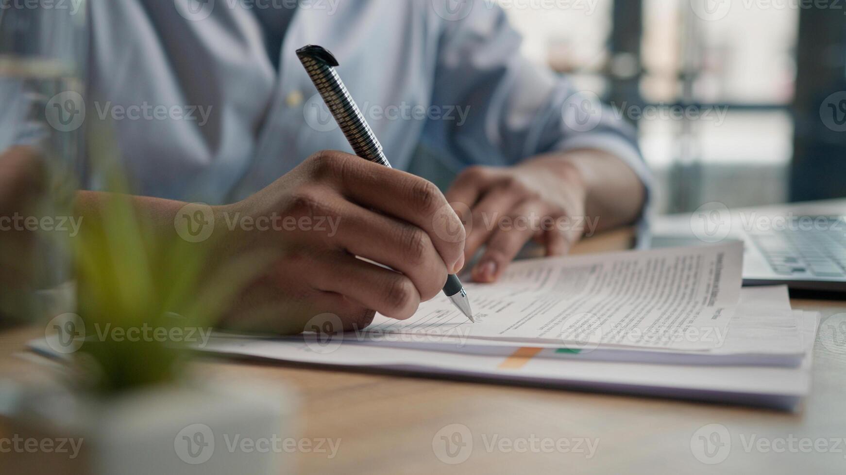 Close up unrecognizable man businessman writing paperwork report on desktop male hands signing business documents on office table student write educational test english exam studying in university photo