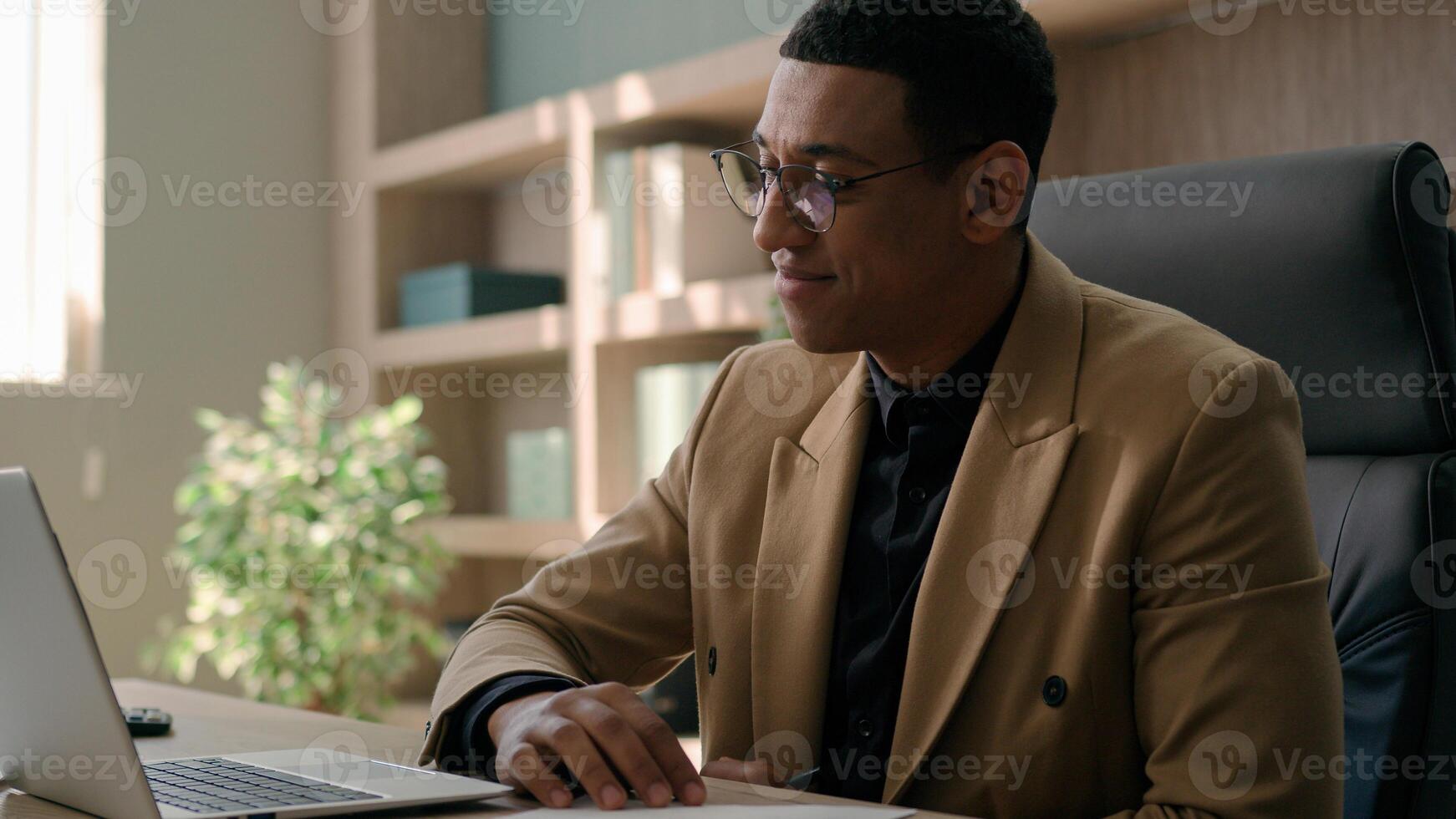 African American man accountant businessman manager analyst write notes data information writing business budget project report paperwork in office studying online with laptop educational course smile photo