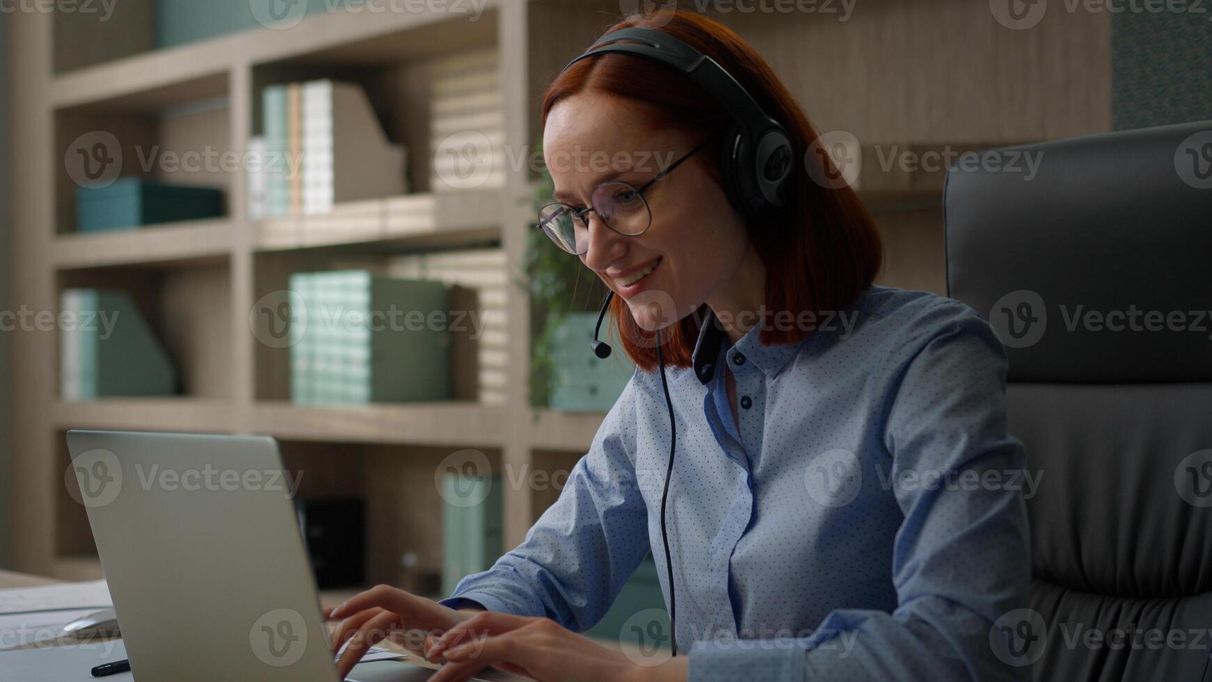 Caucasian smiling businesswoman business virtual meeting conference in office woman girl in headset communicate call center operator talk customer online webcam computer talking helpline manager photo