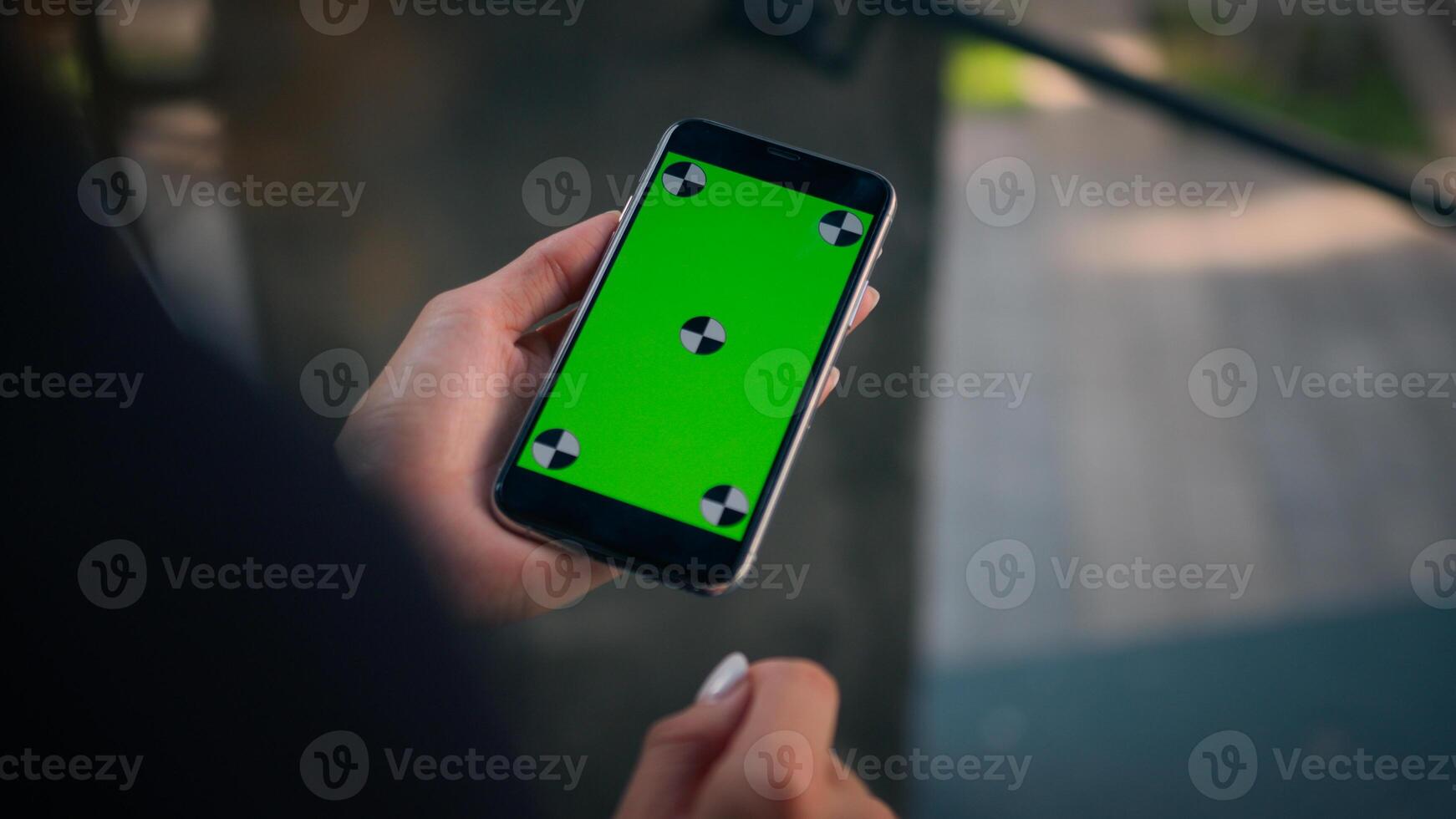 Rear over shoulder view businesswoman using smartphone green screen chroma key mobile mockup unknown girl woman hold phone with copy space cellphone device business app online order in city outdoors photo