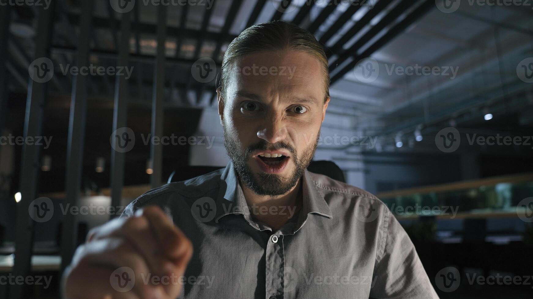 Business contract problem report mistake Caucasian angry aggressive yelling scolding businessman at dark evening office annoyed employee man talking shouting at camera call with papers documents photo