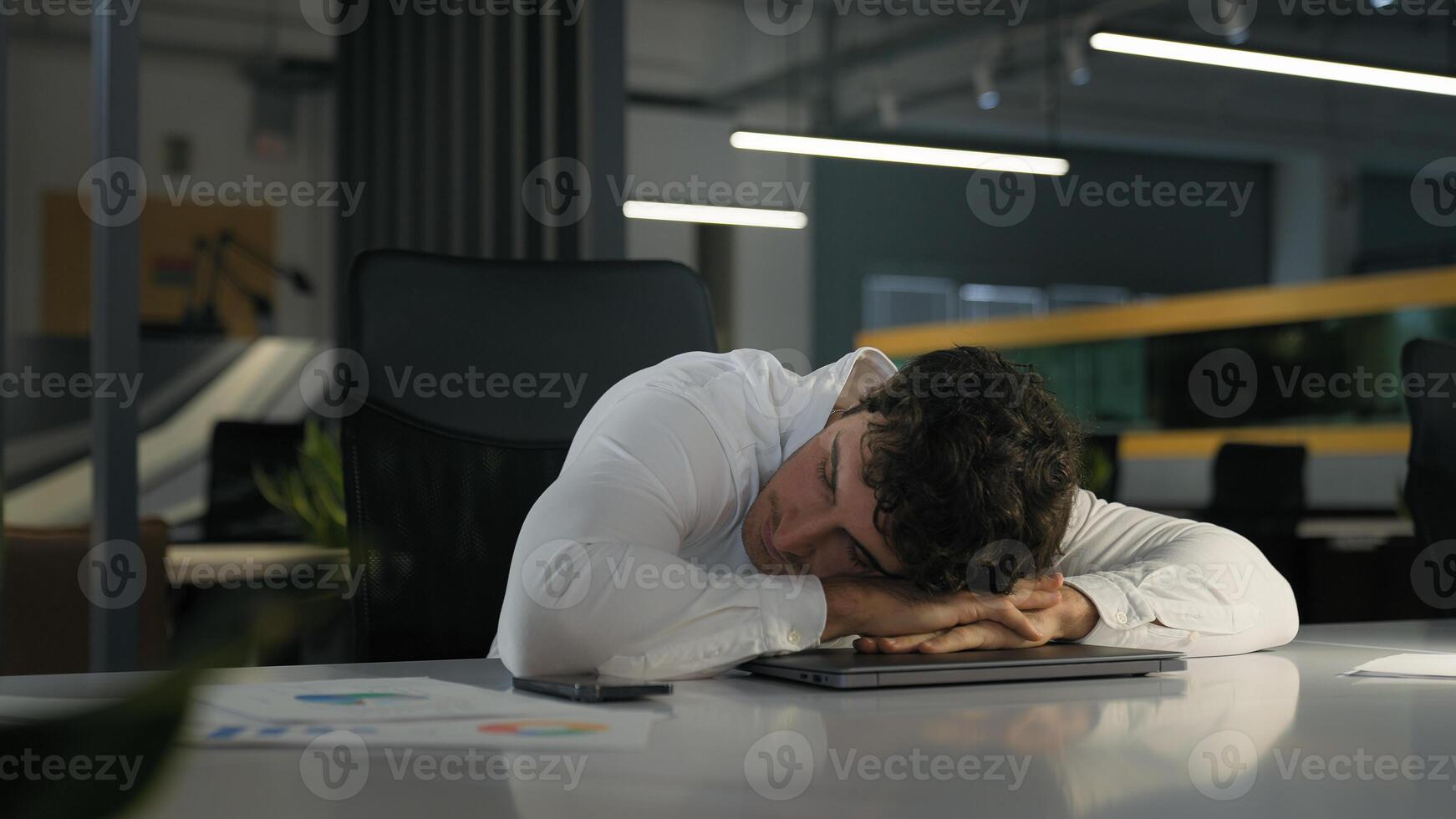Tired exhausted Caucasian businessman finish work night evening office sleeping relax on computer on table need sleep insomnia disorder fatigued male overworked overtime working business man deadline photo