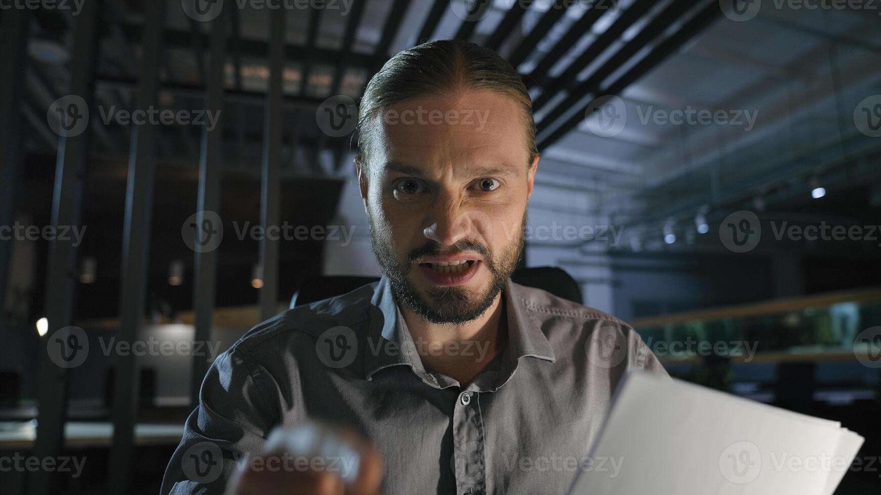 Web cam view conference distant online call conflict quarrel problem communication webcam male businessman argue talk speak at camera hold bad papers documents in dark office business man angry photo